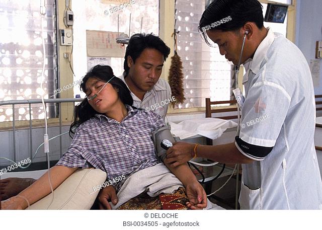 A HOSPITAL IN ASIA<BR>Photo essay for press only.<BR>Taking patient's blood pressure during consultation in Laos