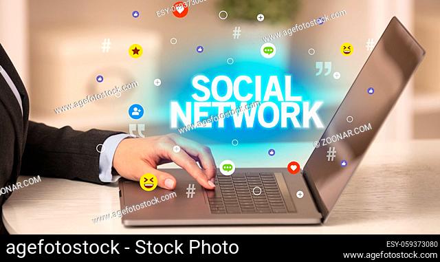 Freelance woman using laptop with SOCIAL NETWORK inscription, Social media concept