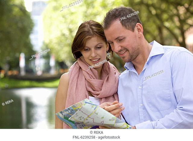 Young couple reading map