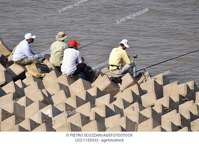 Phnom Penh (Cambodia): men fishing by the Sisowath Quay, at the confluence of the Tonlé Sap, Mekong, and Bassac rivers