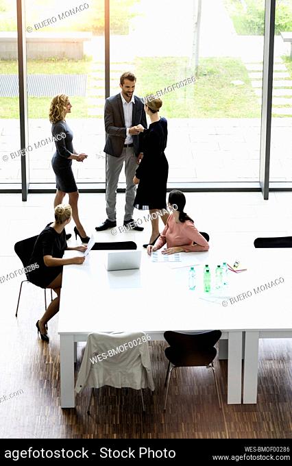 Business people shaking hands in modern office conference room