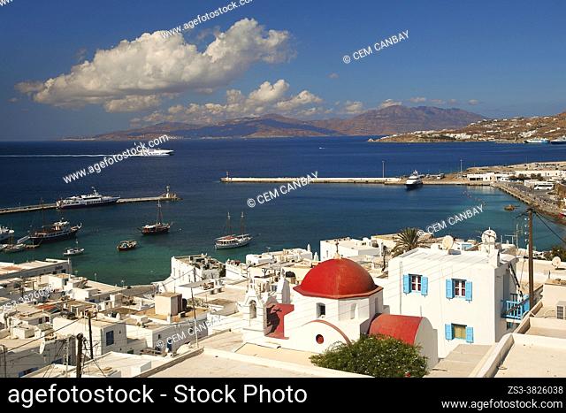 View to the old port with a red domed church in the foreground at the town center, Mykonos Island, Cyclades Islands, Greek Islands, Greece, Europe