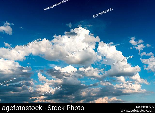 Cloudy sky before a sunset over blue sky in the daytime in summer - sky landscape