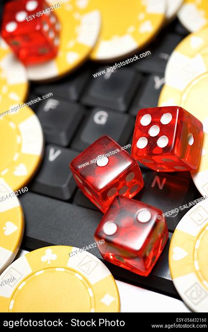 Casino chips and dices stacking on a laptop