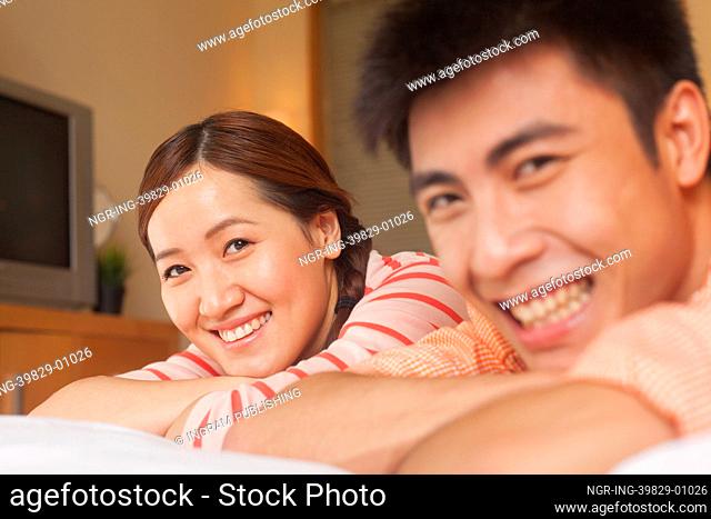 Young Couple Lying on Bed
