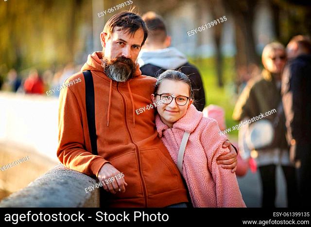 Portrait of a teenage daughter with dad outdoors. Selective focus on the girl