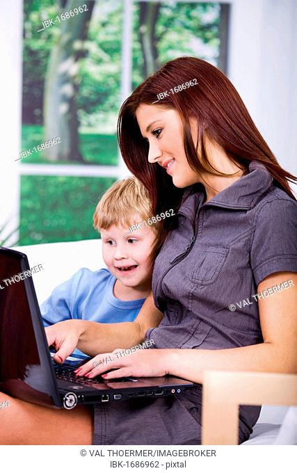 Young woman and boy with laptop