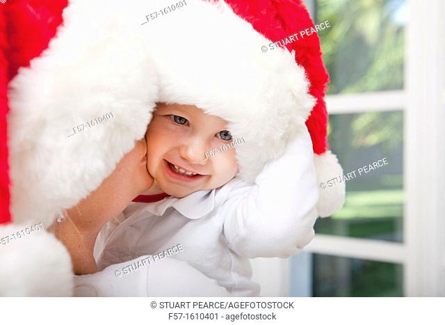 Mother and child wearing Santa hats