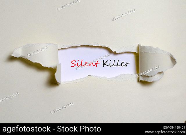 The word silent killer appearing behind torn paper