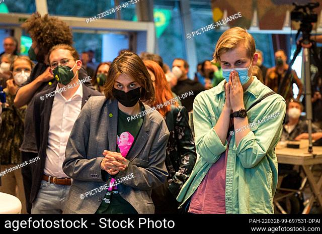 dpatop - 27 March 2022, Saarland, Saarbrücken: Supporters of the Green Party react to the projections for the state election at the election party