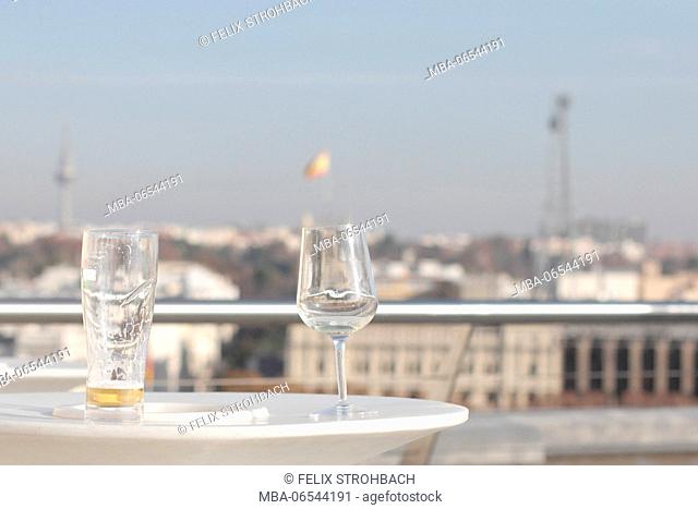 Empty glasses on a roof terrace over Madrid
