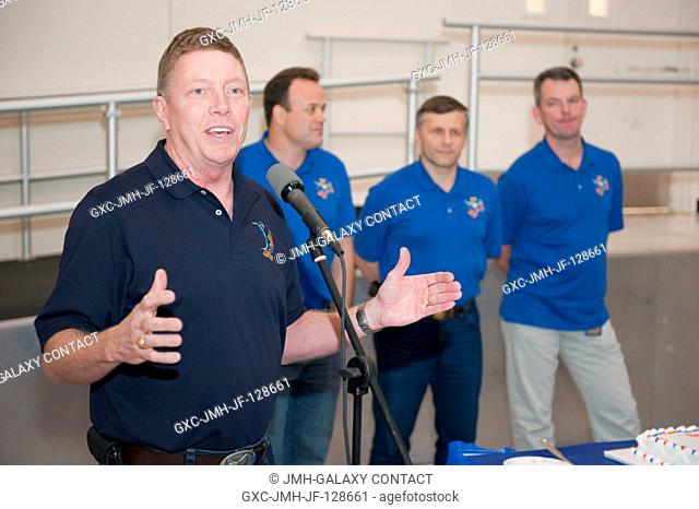 NASA astronaut Mike Fossum, Expedition 28 flight engineer and Expedition 29 commander, speaks to a crowd during a cake-cutting ceremony in the Jake Garn...