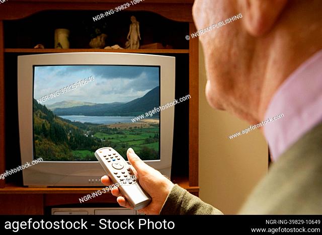 Senior man watching television
