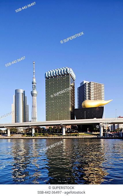 Tokyo Sky Tree and business area skyline at the waterfront, Sumida River, Asakusa, Tokyo, Japan