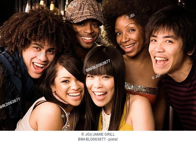 Multi-ethnic friends posing in nightclub
