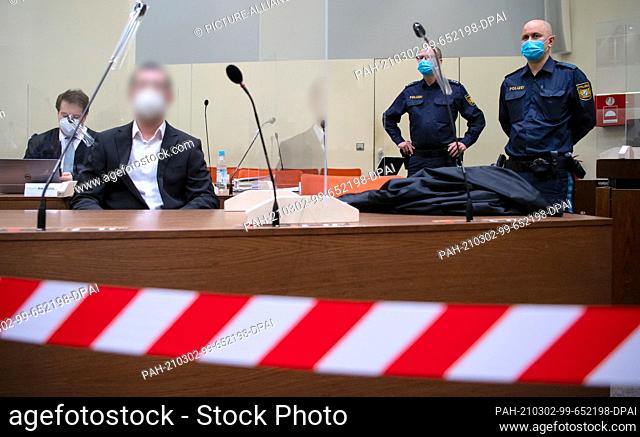 02 March 2021, Bavaria, Munich: The man accused of 31 counts of attempted murder, aggravated arson and preparation of an act of violence endangering the state...