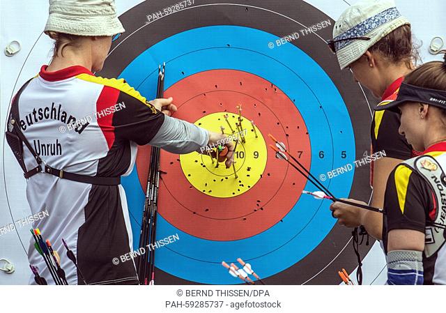 Germany's Lisa Unruh (L-R), Elena Richter and Karina Winter check the target during practise session prior the Archery Women's Team quarterfinal at the Baku...