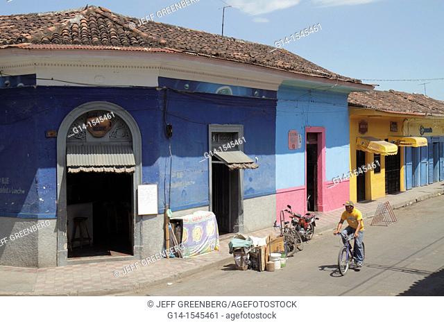 Nicaragua, Granada, Calle Vega, colonial heritage, neighborhood, street scene, corner, building, business, colorful, cyclist, Hispanic, man, roof tiles