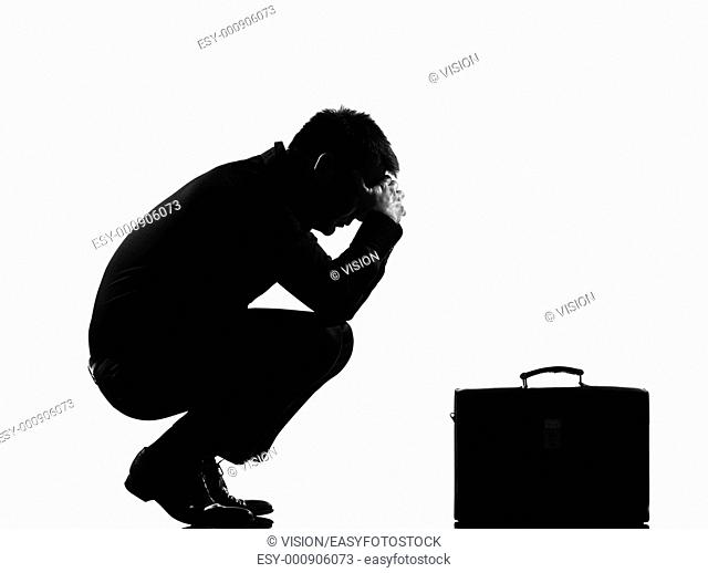 silhouette caucasian business man expressing fatigue despair tired behavior briefcase full length on studio isolated white background