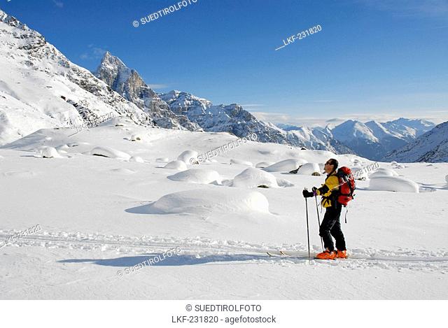 Cross-country skier in a winter landscape under blue sky, Pflerscher valley, South Tyrol, Italy, Europe