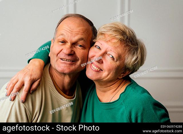 Elderly couple hugging and smiling. Happy loving caring people. Caucasian retired man and woman. valentines day. High quality photo
