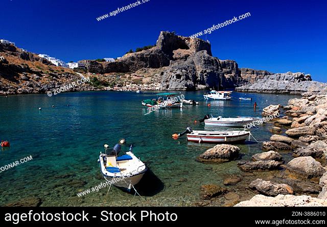 Beautiful St Pauls Bay shadowed by the temple and castle ruins at Lindos