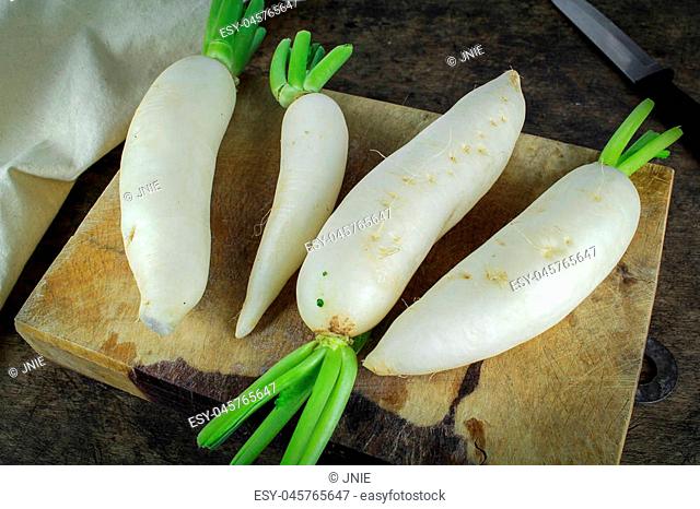 fresh slices white radish on wooden background, healthy vegatable