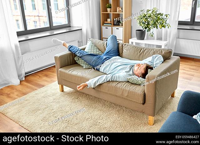 young man sleeping on sofa at home