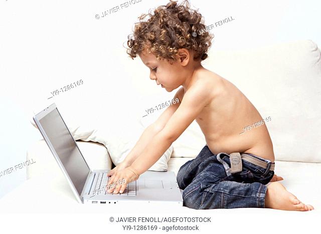 LITTLE BOY WITH LAPTOP COMPUTER