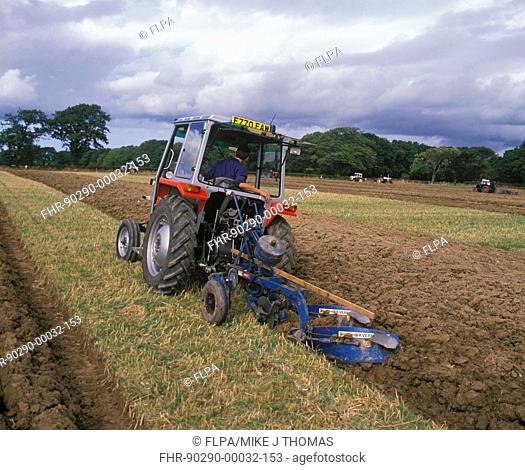 Tractor ploughing stubble field during ploughing competition, Wales
