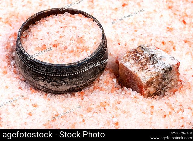 vintage silver salt cellar, rough natural pink Halite mineral and grained Himalayan Salt close up