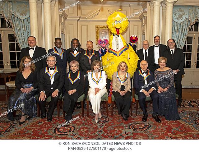 The recipients of the 42nd Annual Kennedy Center Honors pose for a group photo following a dinner at the United States Department of State in Washington, D