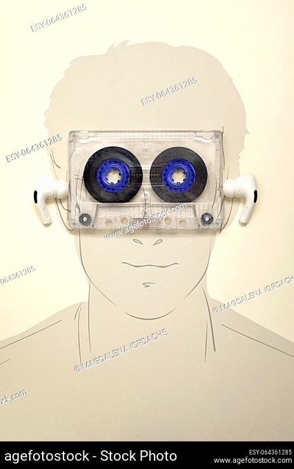 Abstract Audio Cassette over Man Face. Man Listen Music With Earphones