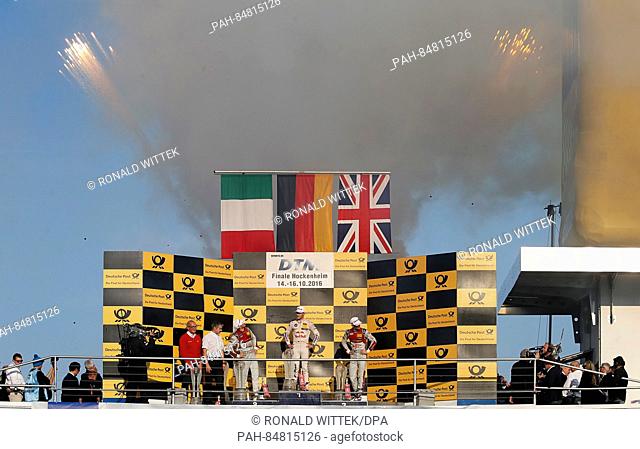 German race driver Marco Wittmann (M) stands on the podium durinhg a champagne shower with the Italian Edoardo Mortara (l) and the British Jamie Green during...