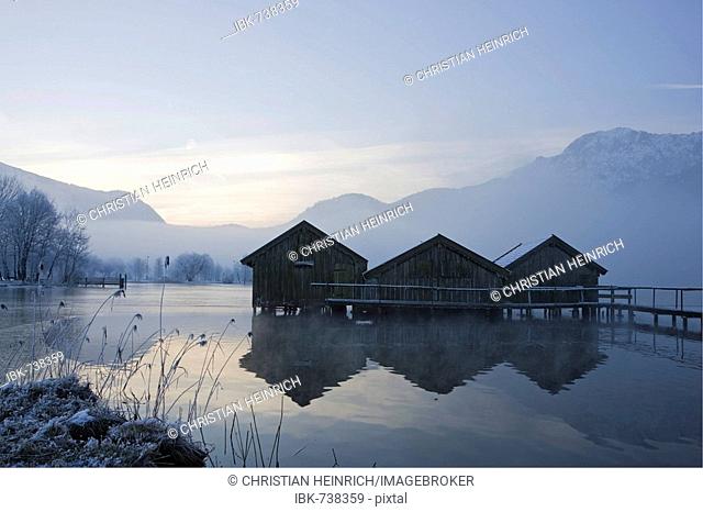 Boathouses, frost-covered reeds on the shore of the Kochelsee (Lake Kochel) enshrouded in mist, Bavarian pre-Alps, Upper Bavaria, Bavaria, Germany, Europe