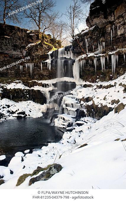 View of partially frozen waterfall with icicles, Uldale Force, River Rawthey, Baugh Fell, Howgill Fells, Cumbria, England, April