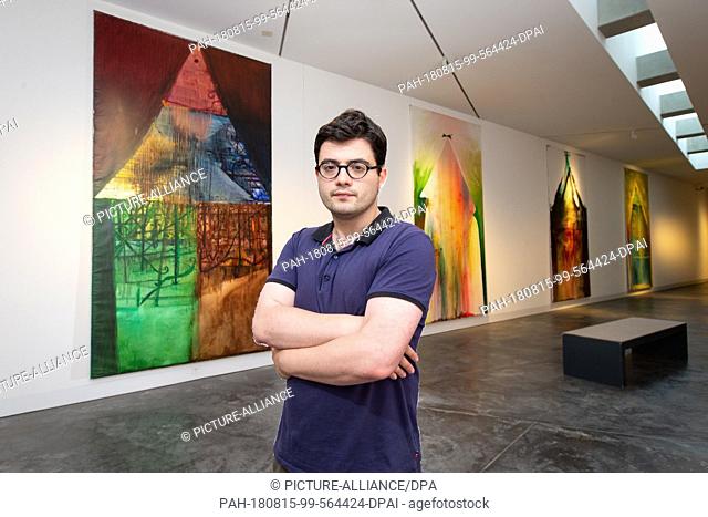 09 August 2018, Germany, Osnabrueck: Russian artist Yury Kharschenko stands in front of his paintings ""Issehar"" (oil on canvas, 2010, L-R)