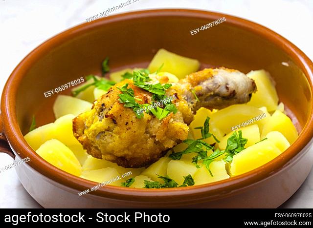 fried chicken leg with potatoes