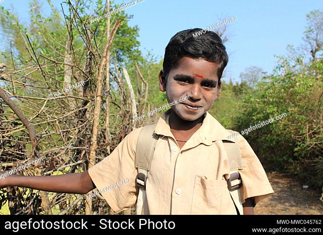 Portrait of an smiling boy on his way to school. India