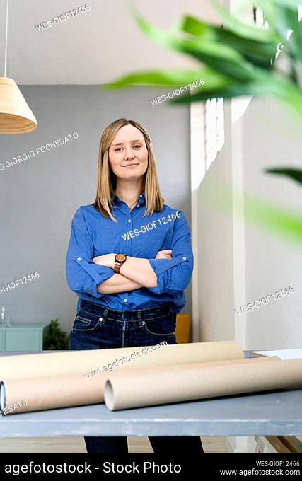 Businesswoman with arms crossed standing in office