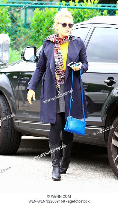 Busy Philipps wearing black and blue with rain coat, handbag and nails out complimented with a bright yellow top, and about running errands Featuring: Busy...