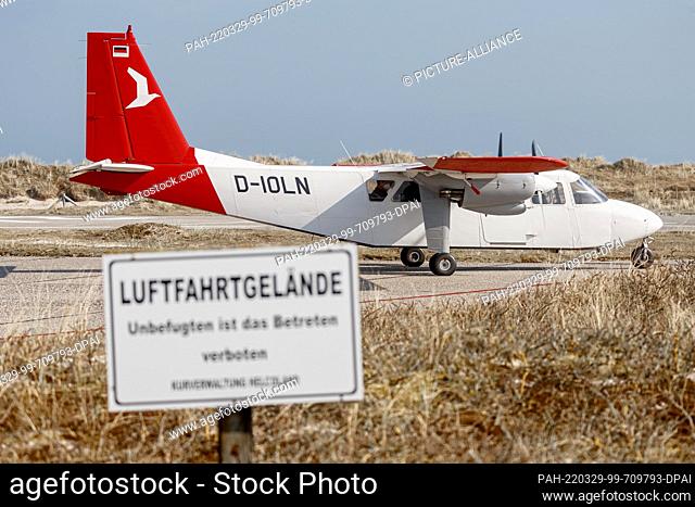25 March 2022, Schleswig-Holstein, Helgoland: A Britten Norman Islander with nine seats of the Ostfriesischer Flug-Dienst (OFD) stands on a taxiway of the...