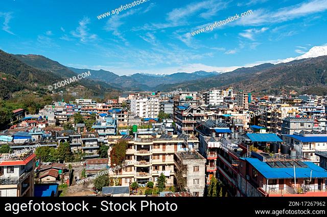 The cityscape of Pokhara with the Annapurna mountain range covered in snow at central Nepal, Asia