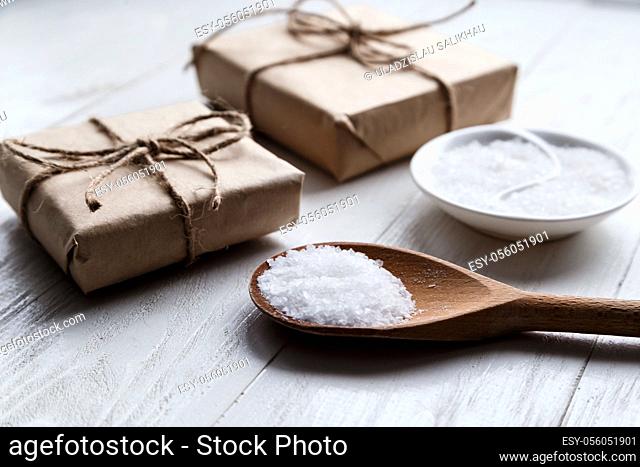 sea salt on wooden background with gift boxes