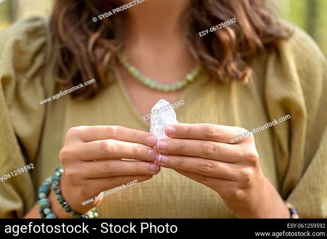 close up of woman holding magical crystal