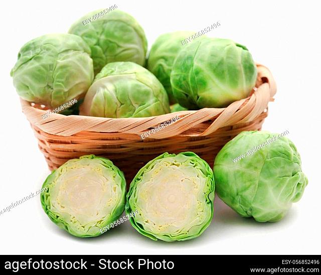 Rosenkohl or Brussels sprout in a basket isolated over white background