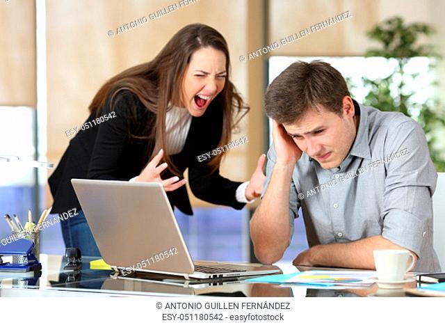 Businesswoman harassing an intern shouting and scolding at office