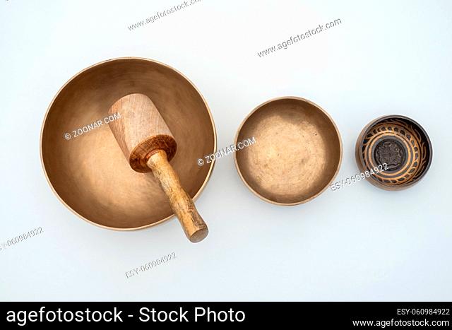 Flat lay composition of Ancient hand crafted traditional Tibetan meditation and healing singing bowls made from 7 sacred metals which are typical accessories...