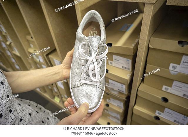 A discerning shopper chooses Toms brand footwear in a shoe store in New York on Thursday, May 3, 2018. Because of debt incurred in 2004 when it was taken over...