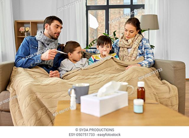 family with ill children having fever at home